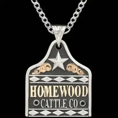 A cow tag necklace featuring personalized lettering, silver diamonds and star figures 